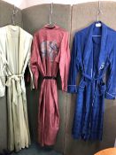 THREE SILK DRESSING GOWNS, TO INCLUDE A NAVY HEALTH EXAMPLE WITH BLUE PATTERN,A GREEN MOALIJIA