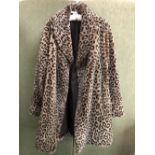 COAT: A NUAGE ANIMAL PRINT FAUX FUR COAT.