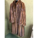 COAT. A FULL LENGTH BROWN FUR JACKET. PIT TO PIT 53cm, SHOULDER TO HEM 117cm SHOULDER TO CUFF 63cm.