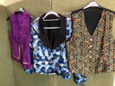 A SAPPHIRE SIZE 12 SILVER AND BLUE EVENING JACKET, TOGETHER WITH TWO WAISTCOATS, ONE PURPLE TAN