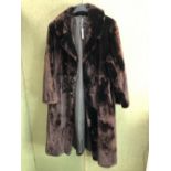 COAT. A HARRODS 3/4 LENGTH FUR COAT. PIT TO PIT 54cm, SHOULDER TO HEM 112cm SHOULDER TO CUFF 61cm.