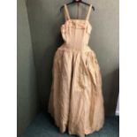 DRESS. A 1950'S? GOLD FULL LENGTH GOWN DRESS WITH BONED BODICE AND NETTED UNDERSKIRT.