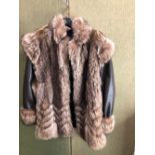 A LISBETH BUCHLER LONDON LADIES FUR AND LEATHER COAT. PIT TO PIT 52cm SHOULDER TO CUFF 59cm SHOULDER