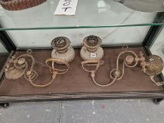 TWO GILT METAL WALL BRACKETS BEARING OIL LAMPS WITH CLEAR GLASS RECEIVERS