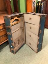 A VINTAGE METAL BOUND TRAVELLING TRUNK