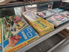 A MATCHBOX MOTORWAY AND ANOTHER BOXED CAR GAME TOGETHER WITH A BOXED MERIT ELECTRIC DERBY HORSE