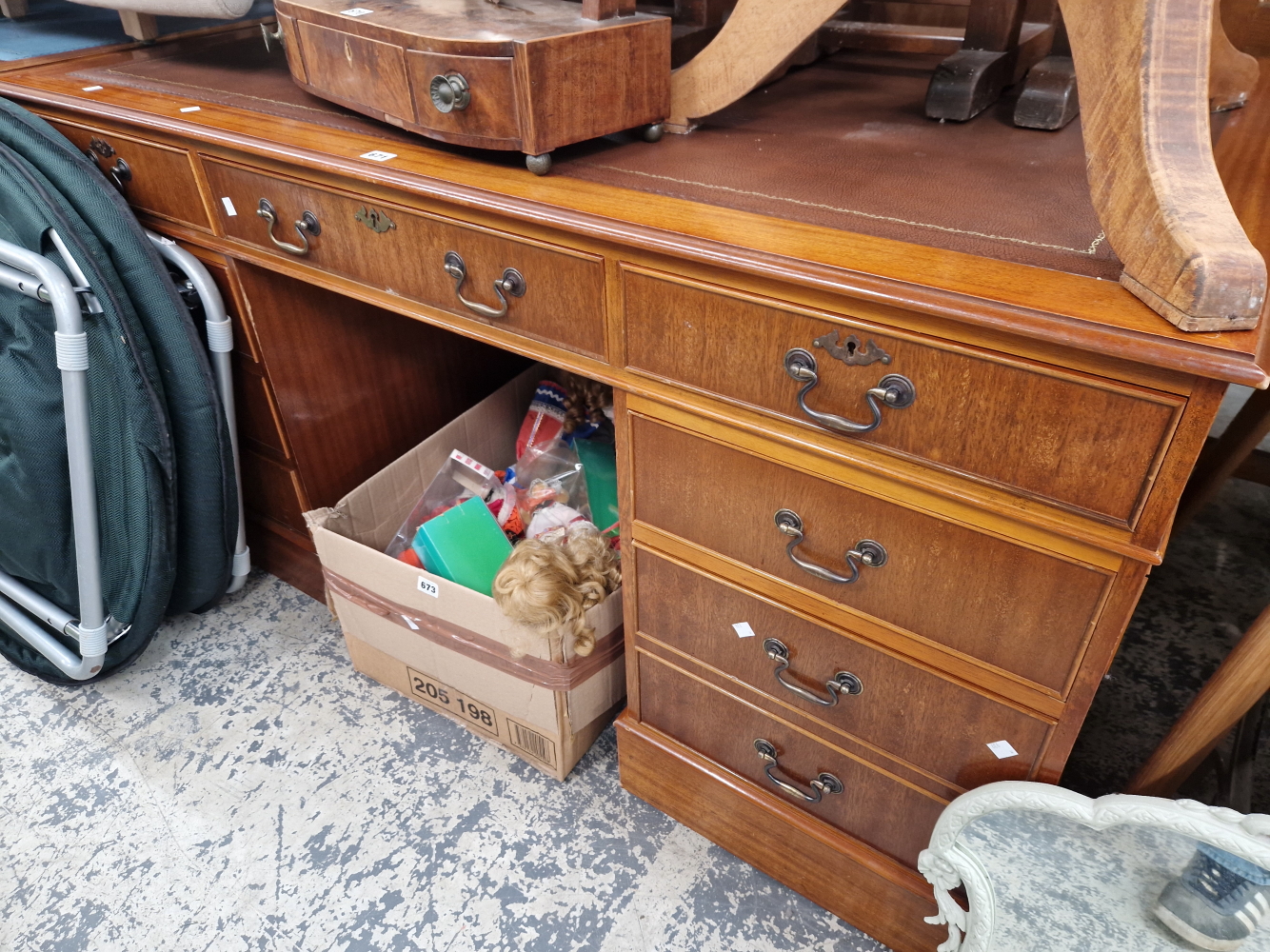 A MODERN MAHOGANY FIVE DRAWER PEDESTAL DESK WITH A RED LEATHER INSET TOP