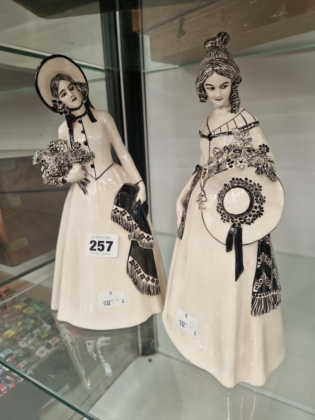 TWO AUSTRIAN ART DECO WHITE POTTERY FIGURES OF CRINOLINE LADIES DETAILED IN BLACK