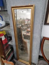 A FULL LENGTH MIRROR IN A GILT FRAME