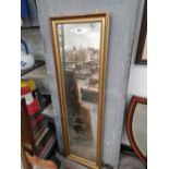 A FULL LENGTH MIRROR IN A GILT FRAME