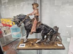 A COLOURED SPELTER COWBOY TABLE LIGHTER
