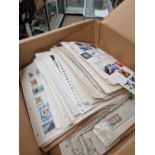 A QUANTITY OF ALL WORLD STAMPS ON ALBUM PAGES.