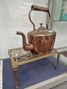 A COPPER KETTLE TOGETHER WITH A BRASS TRIVET