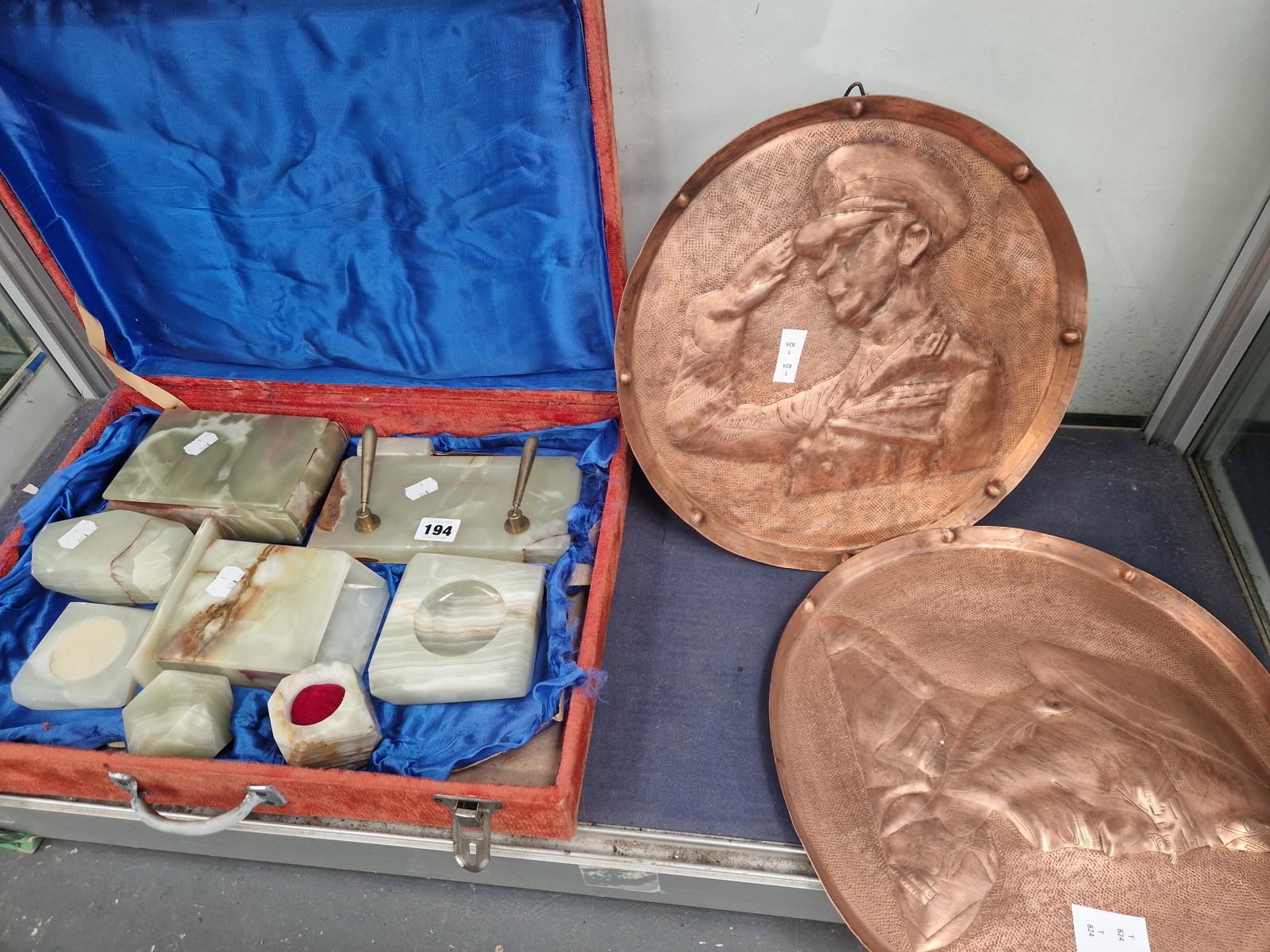 AN AGATE DESK SET TOGETHER WITH TWO REPOUSSE COPPER TRAYS DEPICTING MILITARY CHARACTERS