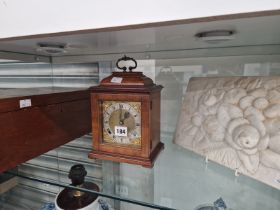 A MAHOGANY CASED STRIKING MANTEL CLOCK, A PLAQUE MOULDED WITH FLOWERS AND A MAHOGANY BOX