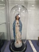 A POLYCHROME FIGURE OF THE MADONNA UNDER A GLASS DOME
