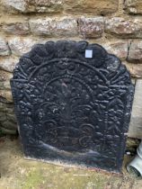 A LARGE ANTIQUE CAST IRON FIRE BACK. H 92cms W 74cms