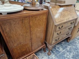 A WALNUT BUREAU ON CARVED CLAW AND BALL LEGS TOGETHER WITH A BOW FRONT TWO DOOR CABINET AND TWO