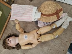 AN ARMAND MARSEILLE 390 BISQUE HEADED DOLL WITH A STRAW HAT AND SOME CLOTHING