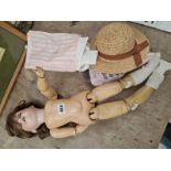 AN ARMAND MARSEILLE 390 BISQUE HEADED DOLL WITH A STRAW HAT AND SOME CLOTHING