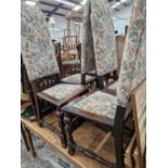 A SET OF FOUR LATE STEWART STYLE OAK DINING CHAIRS WITH UPHOLSTERED BACKS AND SEATS
