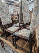 A SET OF FOUR LATE STEWART STYLE OAK DINING CHAIRS WITH UPHOLSTERED BACKS AND SEATS