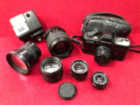 A PENTAX AUTO 110 CAMERA WITH FIVE ADDITIONAL LENSES. 70mm, 20-40mm ZOOM, 50mm, 24mm, 18mm AND A