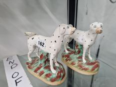 A PAIR OF STAFFORDSHIRE POTTERY DALMATIANS