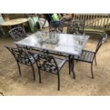 A GLASS AND METAL GARDEN TABLE WITH SIX MATCHING CHAIRS