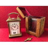 A BRASS CASED CARRIAGE CLOCK WITH A OUTER LEATHER CASE.