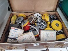 A SUITCASE OF CINE FILM SPOOLS TO INCLUDE BOXES LABELLED SQUASH, TENNIS AND THREE COUNTIES SHOW