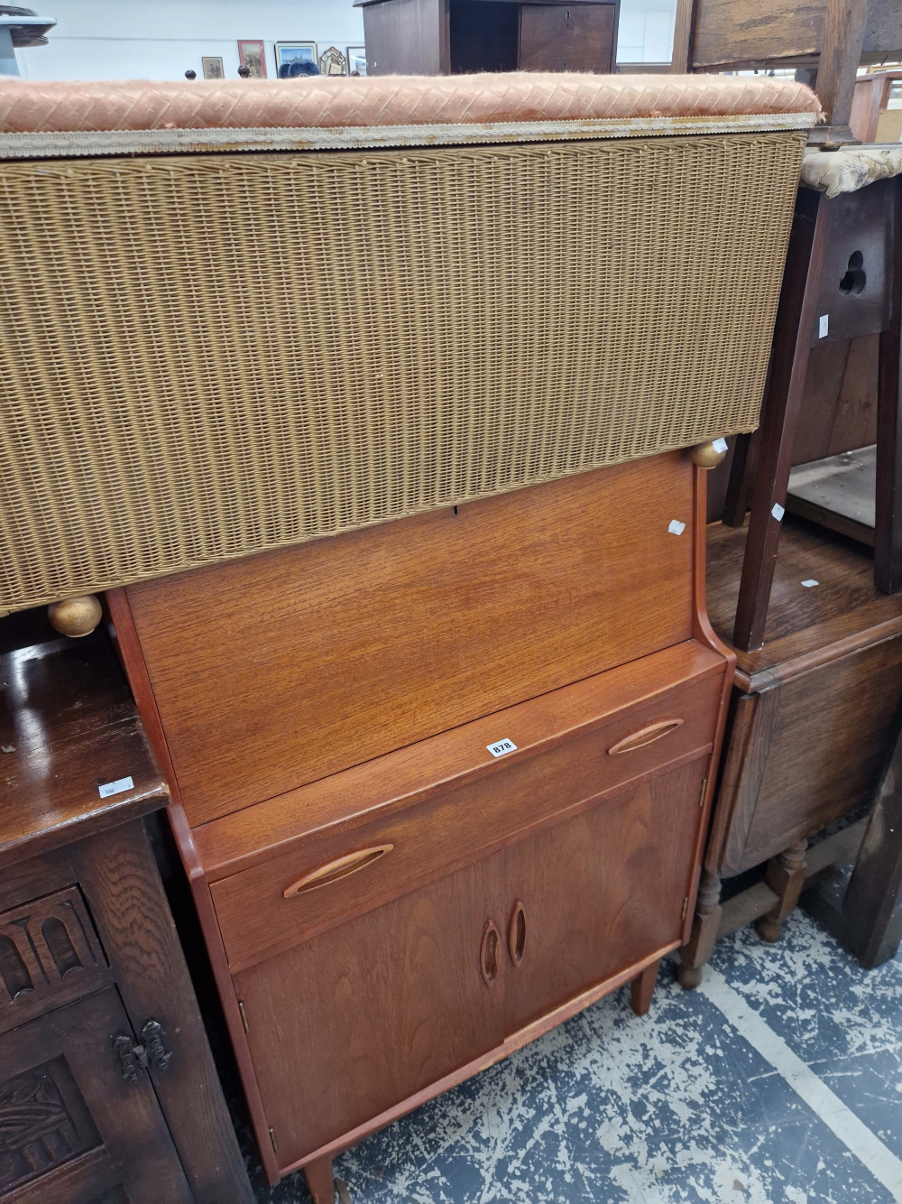 A RETRO TEAK BUREAU AND A LLOYD LOOM OTTOMAN