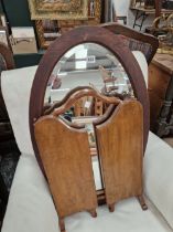 AN OVAL WALL MIRROR AND A TRIPTYCH MIRROR.