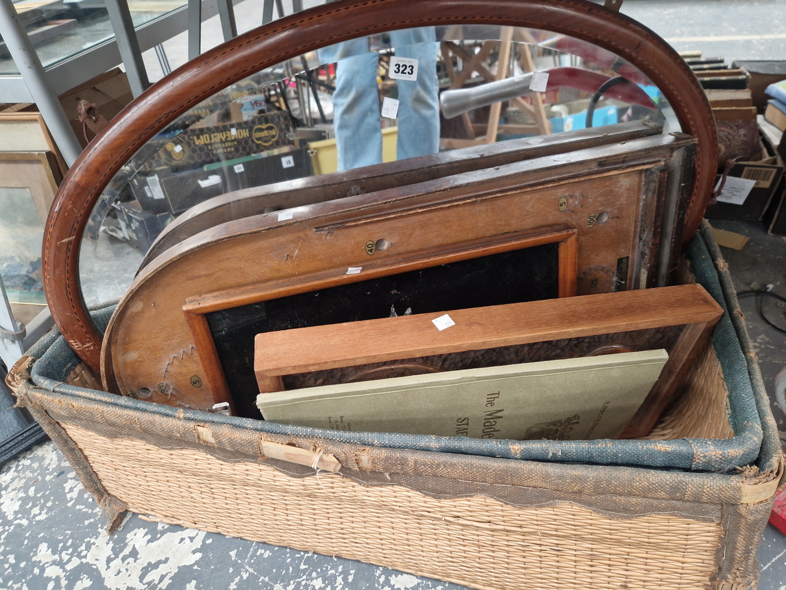 A BASKET CONTAINING TWO CLOCKS, A MIRROR, A PIN BALL GAME AND AN AUCTION CATALOGUE