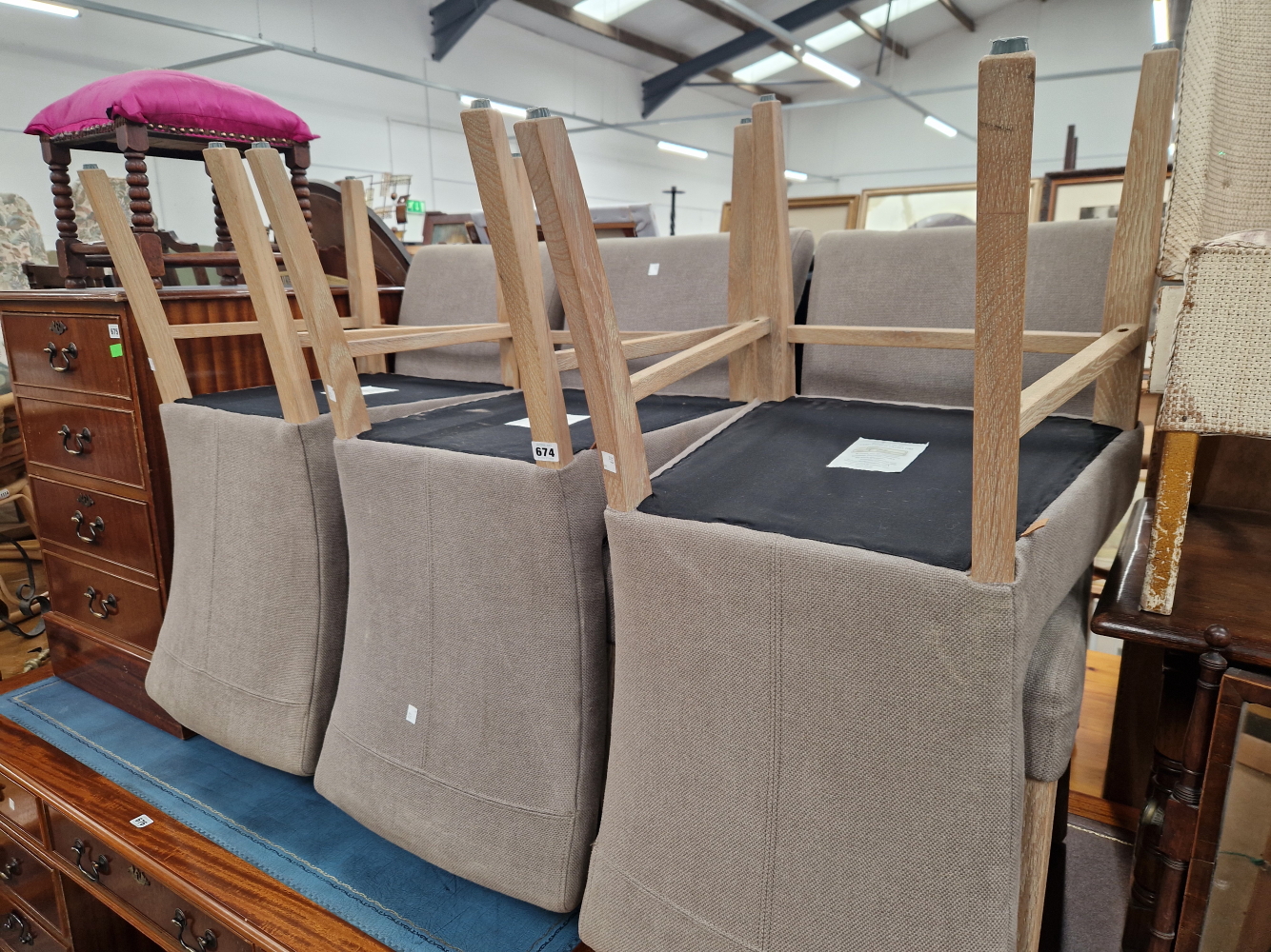 A SET OF SIX LIMED OAK CHAIRS WITH GREY UPHOLSTERED BACKS AND SEATS