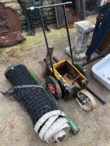 A VINTAGE LINE MARKER AND A TENNIS NET WITH POSTS.