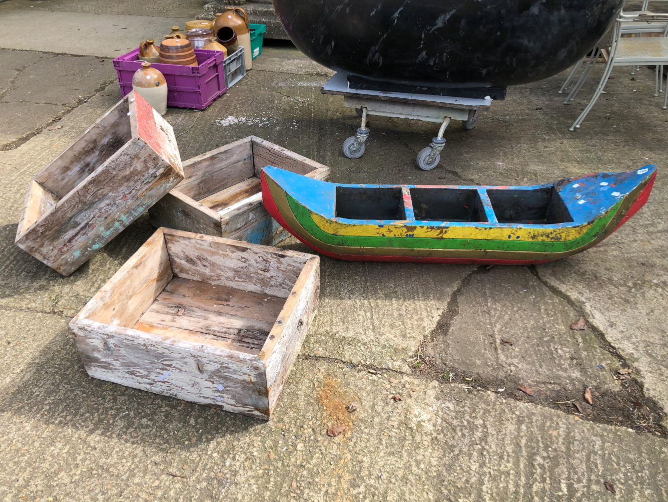 A DRIFT WOOD BOAT FORM GARDEN PLANTER, TOGETHER WITH THREE SIMILAR RECTANGULAR PLANTERS (4)