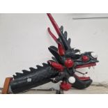 A BLACK AND RED PAINTED COMPOSITION  DRAGONS HEAD. L 90 H 80 D 50 cm