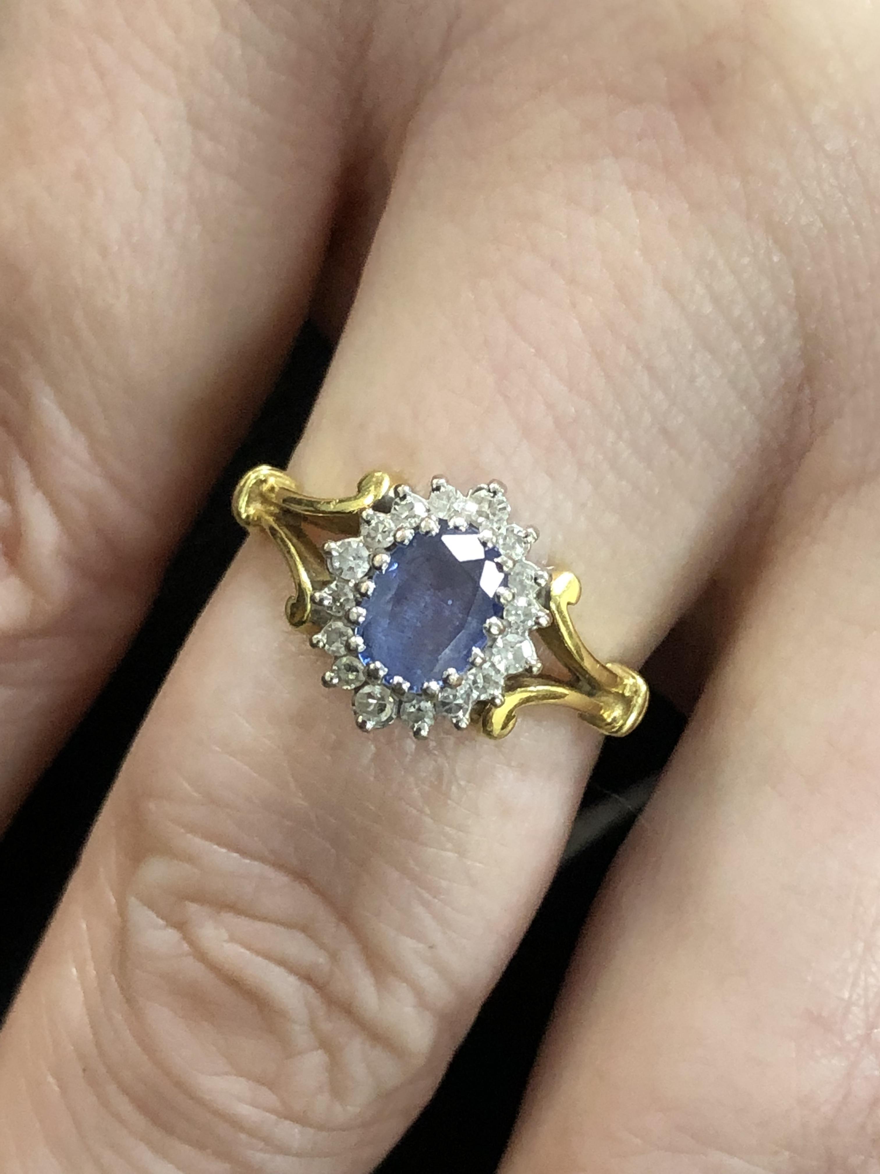 AN 18t HALLMARKED SAPPHIRE AND DIAMOND CLUSTER RING. THE OVAL SAPPHIRE A LIGHT CORNFLOWER BLUE, - Image 5 of 5