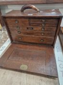 AN OAK UNION CHEST OF SIX DRAWERS CONTAINING CALIPERS AND OTHER TOOLS