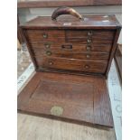 AN OAK UNION CHEST OF SIX DRAWERS CONTAINING CALIPERS AND OTHER TOOLS