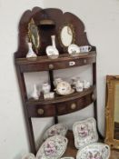 A MAHOGANY MIRROR BACKED CORNER WASH STAND WITH A DRAWER BELOW THE LOWER BOW FRONTED TIER