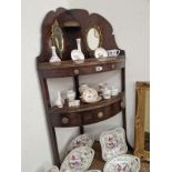 A MAHOGANY MIRROR BACKED CORNER WASH STAND WITH A DRAWER BELOW THE LOWER BOW FRONTED TIER