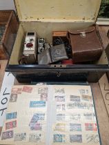 A METAL STRONG BOX TOGETHER WITH TWO STAMP ALBUMS, A SILVER CIGARETTE CASE, A CINE CAMERA, OPERA