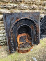 A CAST IRON FIRE SURROUND AND A GRATE.