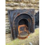 A CAST IRON FIRE SURROUND AND A GRATE.