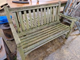 A WOODEN GARDEN BENCH