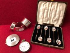 A HALLMARKED SILVER POCKET WATCH, COMPACT, THREE NAPKIN RINGS AND A SET OF SIX COFFEE SPOONS.