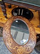 AN ANTIQUE PENWORK FRAMED OVAL MIRROR AND ONE OTHER
