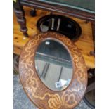 AN ANTIQUE PENWORK FRAMED OVAL MIRROR AND ONE OTHER